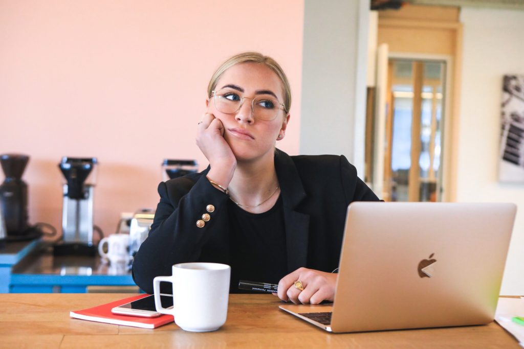 a woman bored at a laptop