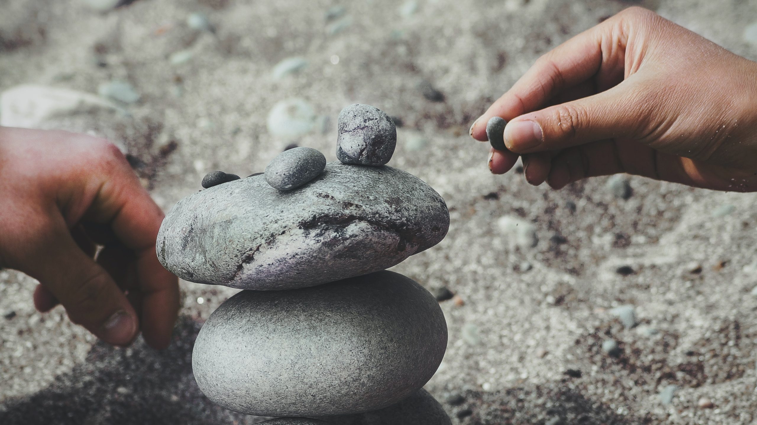 A person balancing rocks to symbolise building trust on social media