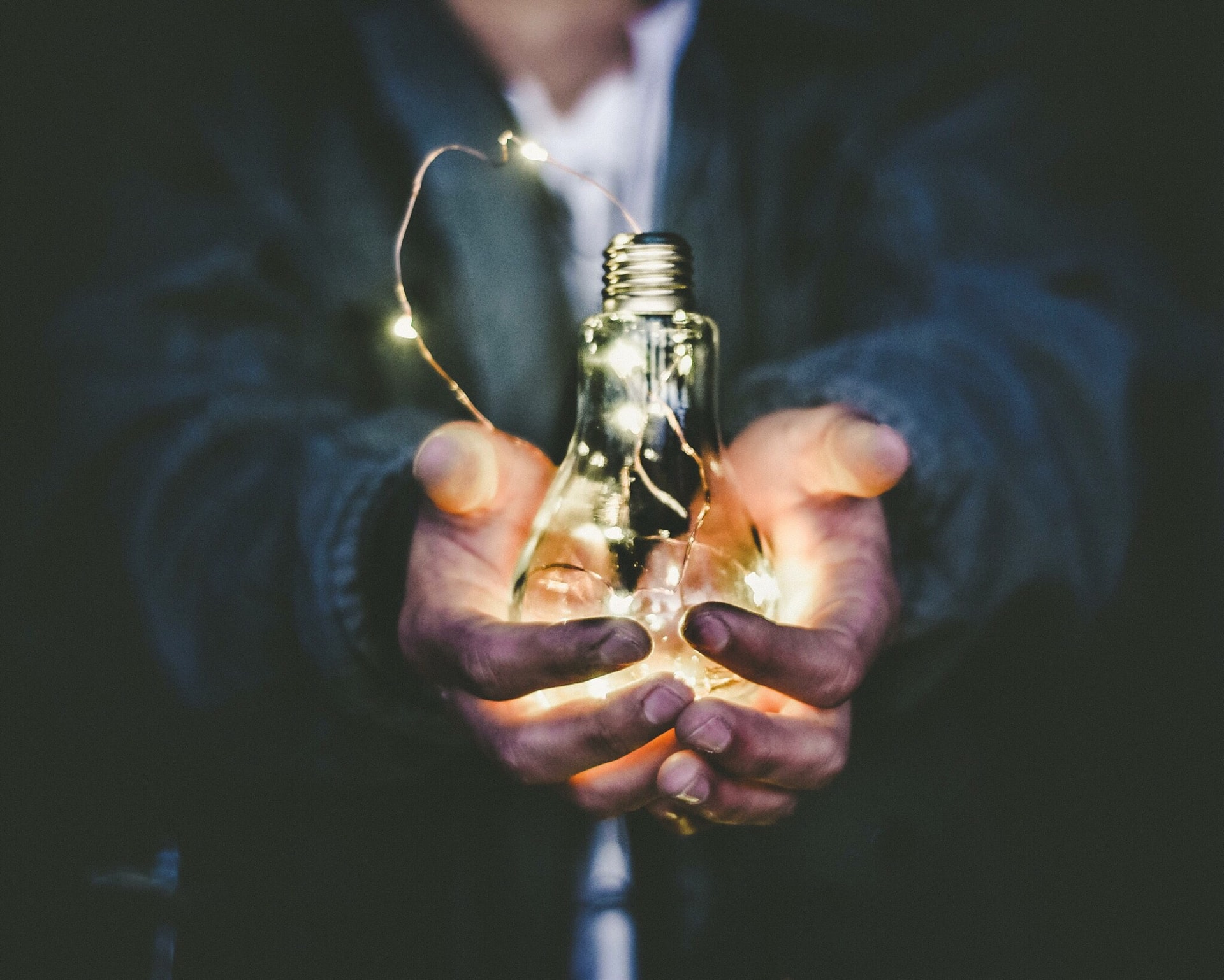 a man holding a lightbulb to symbolise creating content marketing