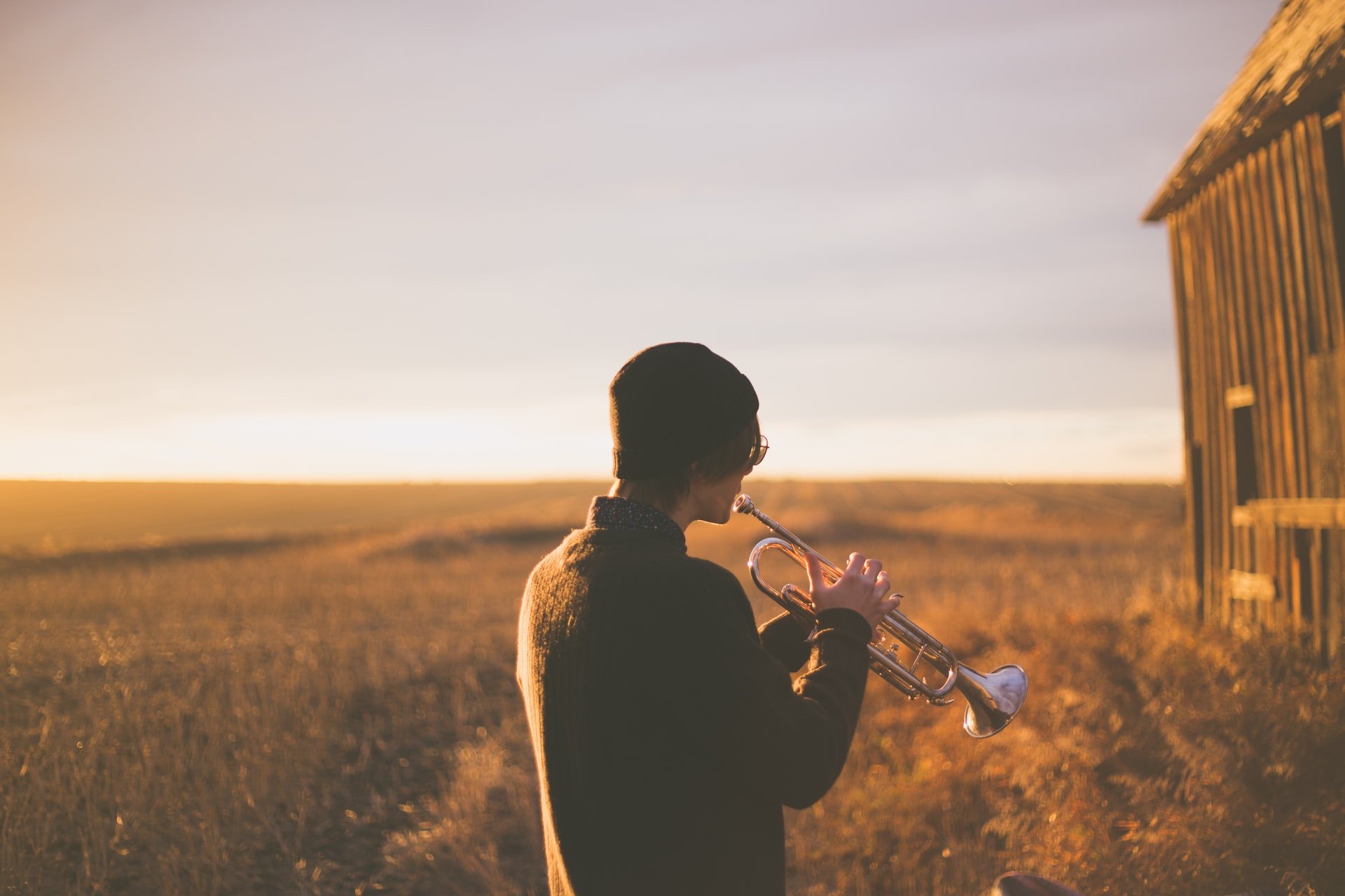 a man playing a trumpet to represent self-promotion 