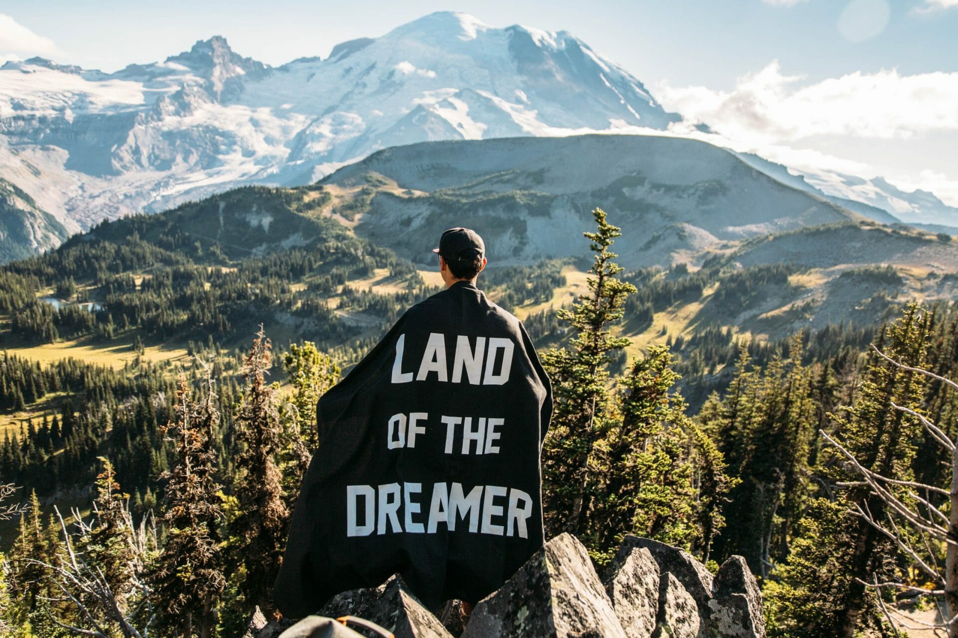 a man with a cape saying 'land of the dreamer'