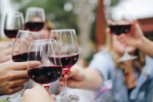 People drinking wine whilst networking at a Christmas party.